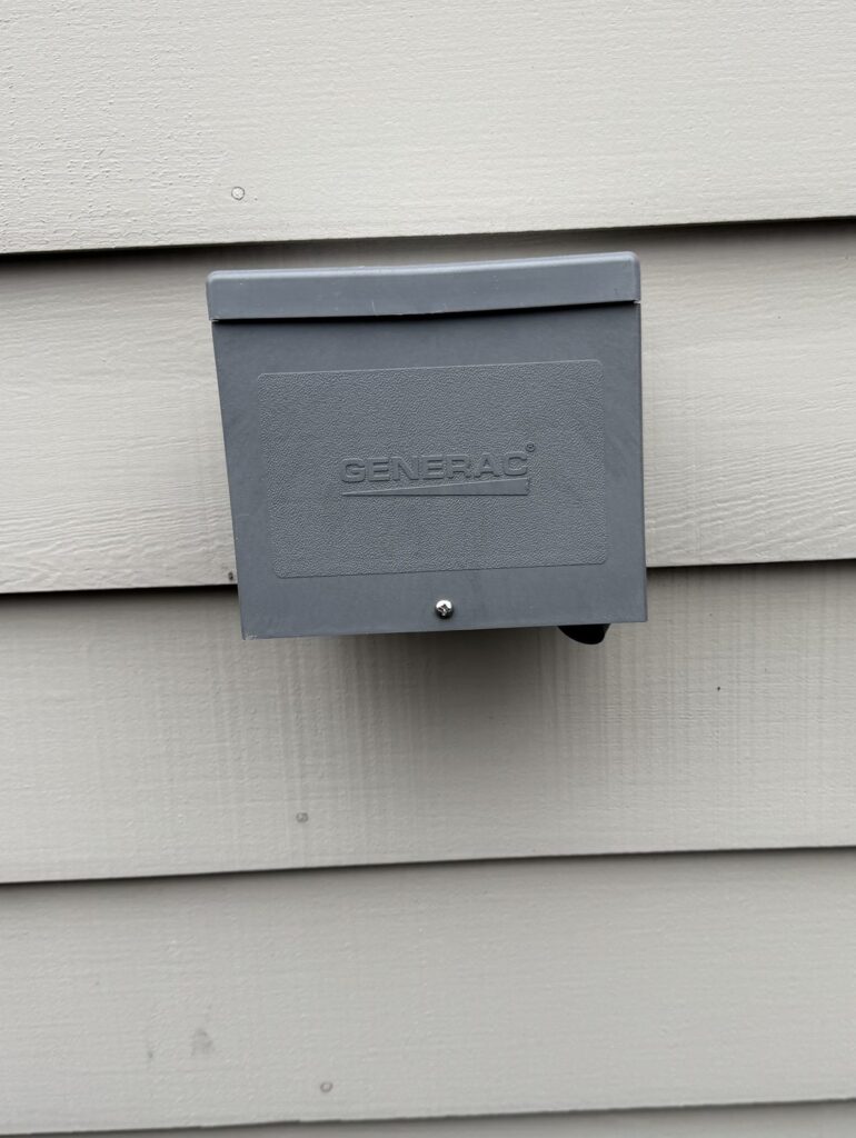 Generac outdoor power inlet box on lap siding for plugging in a portable generator