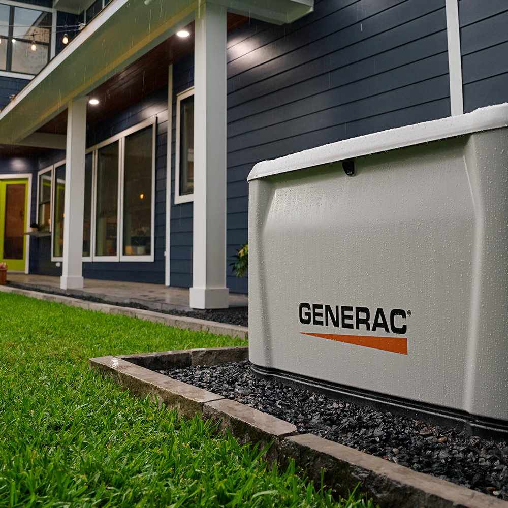 Generac standby generator running in the rain beside a home