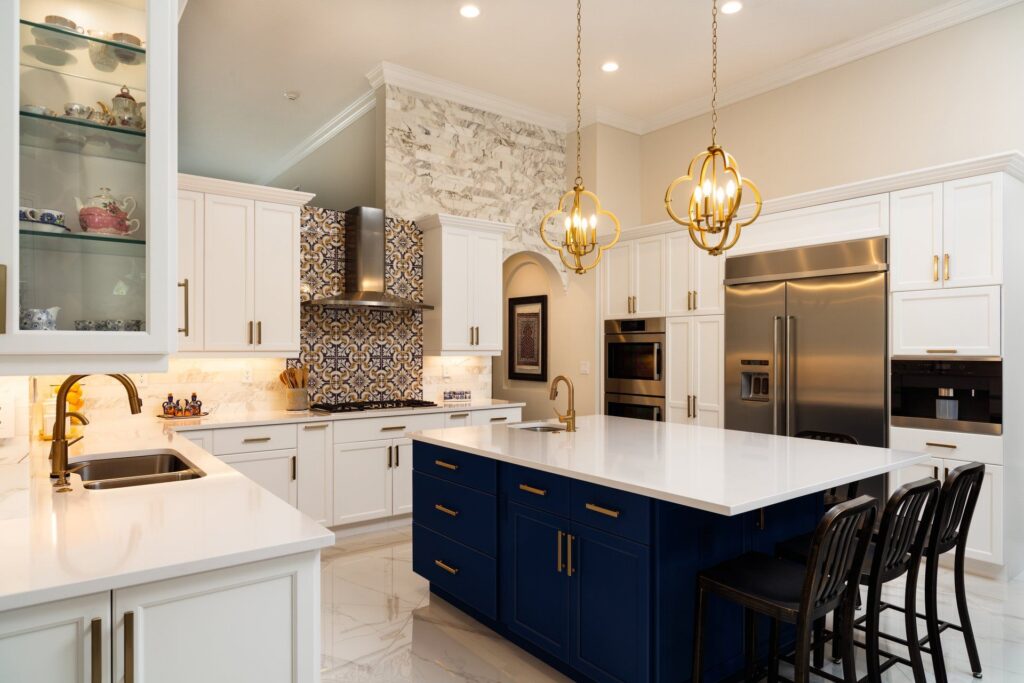 New-construction kitchen with pendant lights over a navy island
